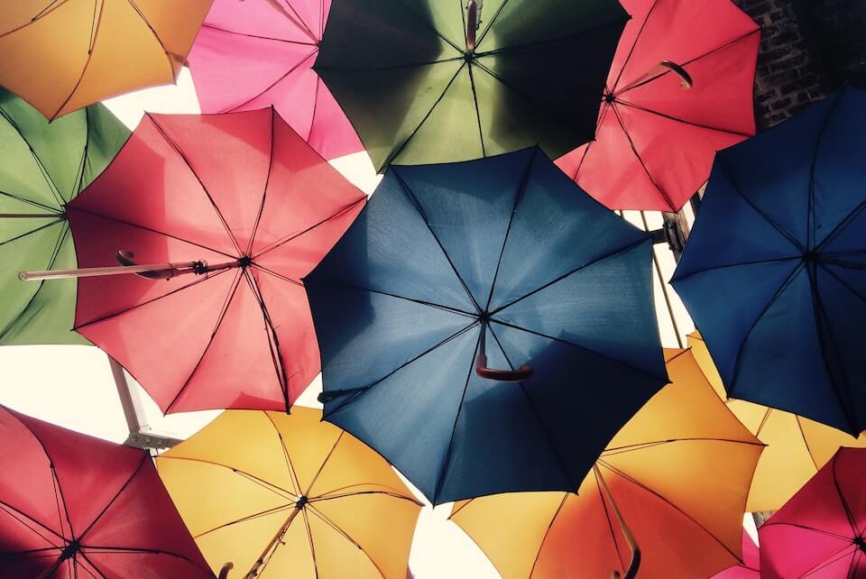 Bright colored umbrellas hanging next to each other